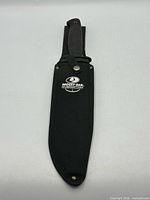 Knife inside branded sheath