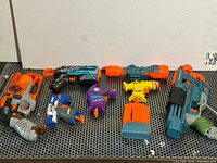 All seven Nerf items lined up on metal surface