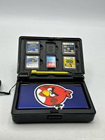 Console and games arranged in storage case