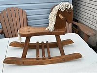 Side view of wooden rocking horse on table