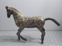 Full side view of black and gold Kashmiri horse figurine