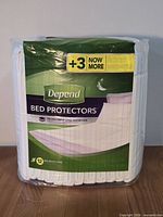Front of sealed Depend Bed Protectors package