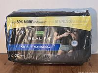Front of sealed 20-count Depend Real Slim Fit underwear pack showing size S/M and Maximum absorbency labeling