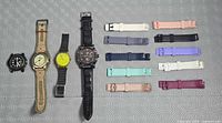 Group shot of five analog watches and ten silicone bands