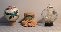Three decorative globes with their stands/holders