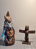Full view of both carved wood pieces