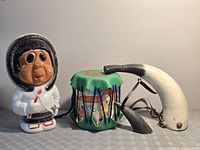 All three items grouped: Inuit coin bank, toy drum, steer horn powder horn