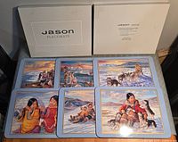 Five placemats displayed plus boxed set lid and base showing designs and quantity