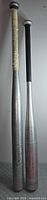 Full view of both aluminum bats side by side