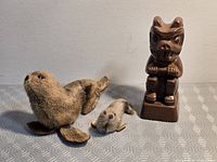 Group shot of wooden totem with adult and pup seal figurines