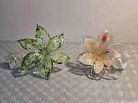 Both glass flowers side by side showing color differences and stems