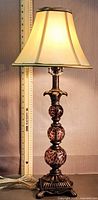 Full view lit showing lamp height with ruler, tortoise glass spheres, cream shade
