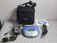 All lot contents: player, adapter, USB cable, CD, carry case