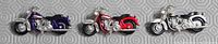 Front view of the three miniature motorcycles showing colors and chrome detail