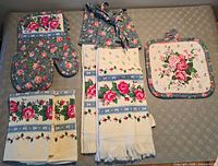 Full set laid out showing mitt, towels, pot holder, apron