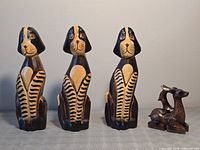 Front view of full lot: three striped dogs and small reindeer