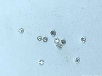 Top view of all loose round brilliant diamonds on white background