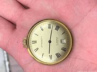 Front view of Dynasty watch head showing dial, crown and case