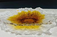 Overall view of signed Humppila amber art glass bowl showing texture, amber center and ruffled rim