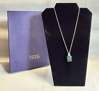 Necklace on black bust next to purple Elizabeth Taylor box