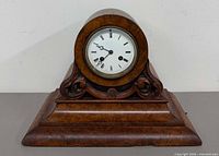 Front view of wooden mantel clock