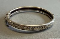 Full view of hinged sterling silver bangle showing etched pattern