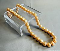Full necklace laid out showing pearls and clasp