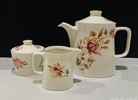 Three-piece porcelain tea set displayed together