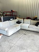 Full view of two-piece beige sectional configured in L-shape