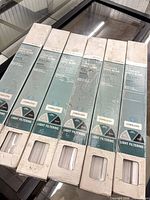All six boxed white cordless vinyl blinds displayed