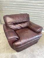 Front view of burgundy faux leather armchair