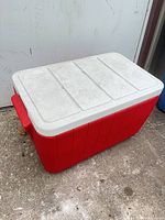 Angled view showing red body, gray lid, side handle