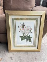 Front view showing floral print, mats and gold frame