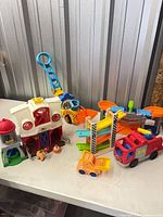 Group shot showing barn, vehicles, track pieces