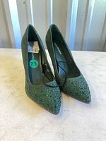 Front view of both pumps showing rhinestone embellishment and size sticker