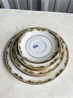 Stack of four Noritake Warrington plates in descending sizes