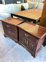 Front view of both nightstands showing design and wear