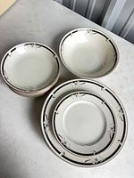 Overhead view of stacked plates and bowls showing pattern and counts