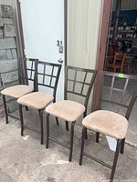 All four matching metal bar stools side by side