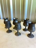 Six pewter goblets group view showing form and patina