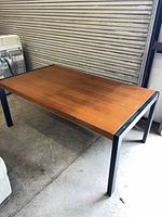 Full view of table showing brown top and black legs