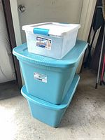 Stacked view showing two teal totes and one clear tote on top