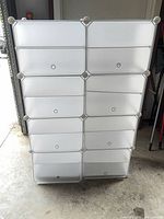 Front view of white translucent 8-cube modular storage unit with doors closed