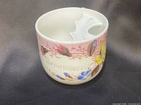 Front view showing floral artwork, interior insert visible