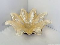 Full view of amber and clear glass flower-petal bowl from front