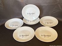 All six plates arranged to show tops with text