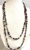 Necklace displayed doubled on bust form showing bead colors and toggle clasp