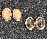 Front view of both earring pairs showing stones and goldtone settings on black background