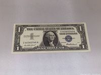 Full view of the 1957 $1 silver certificate front showing serial number and blue seal