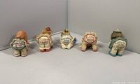 Rear view showing phrases on all five figurines
